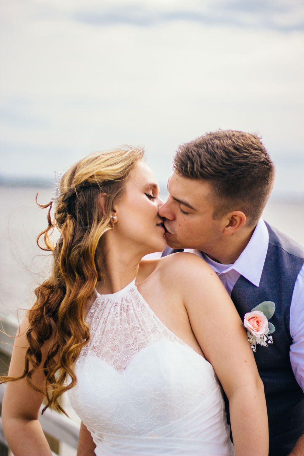 couple kissing on southport nc beach dock wedding photo