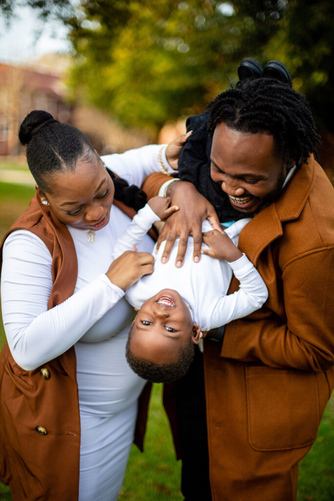 black mom and dad playing with son chic and fun family portrait