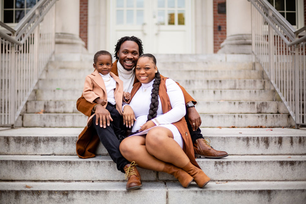 stylish dressed black family sitting on stairs at east carolina university