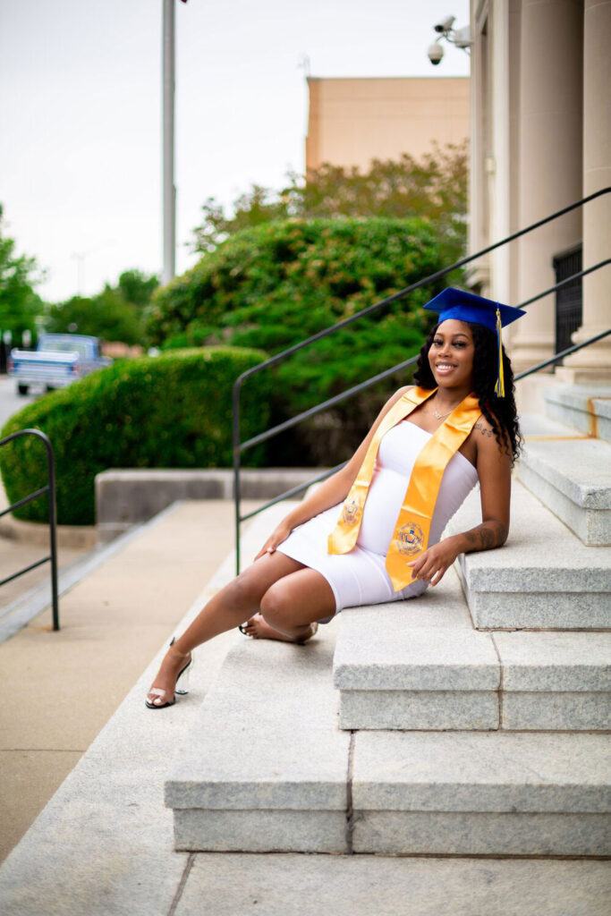 girl sitting on stairs cap and gown photos in greenville nc