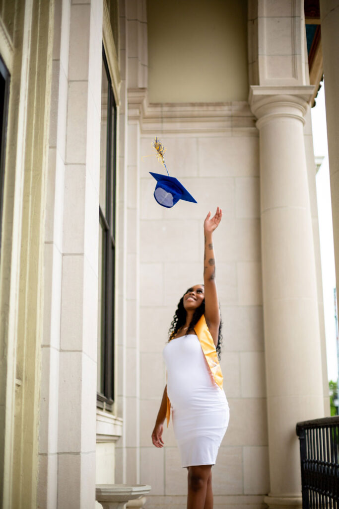 black girl in white dress cap and gown toss