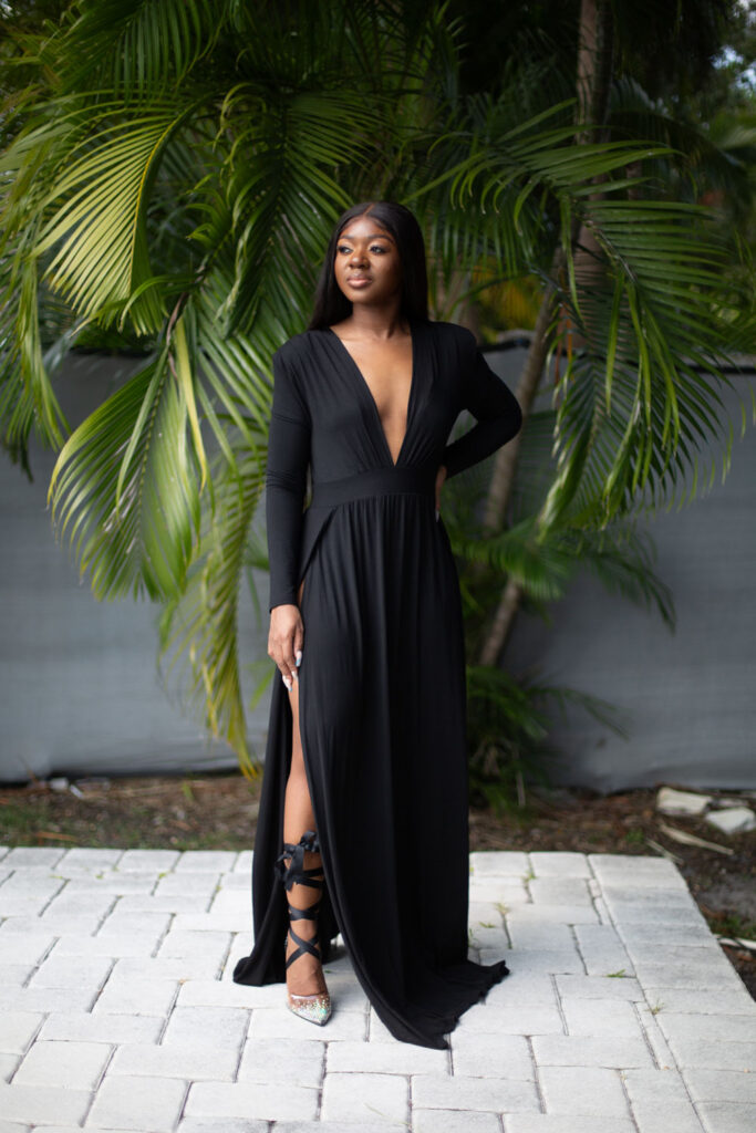 Elegant black maxi dress poolside portrait during a birthday photoshoot at a Miami Airbnb.