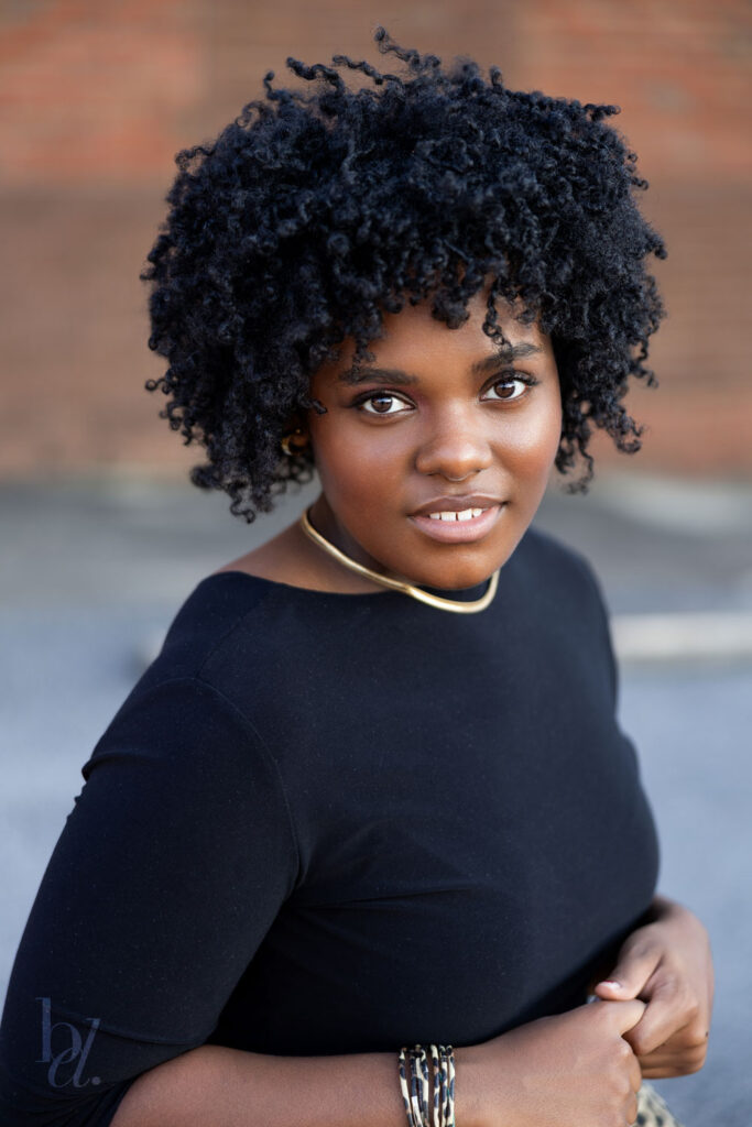 simple senior headshot portrait in downtown clayton nc black girl with natural high afro