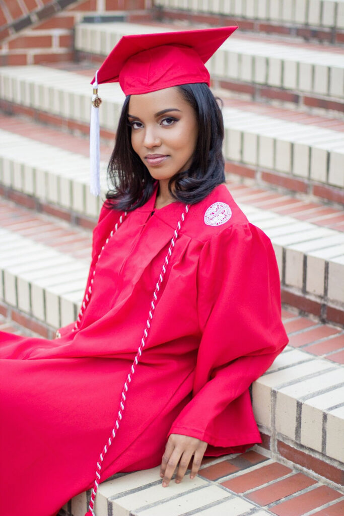 Black girl smiling during her NC State senior portrait session