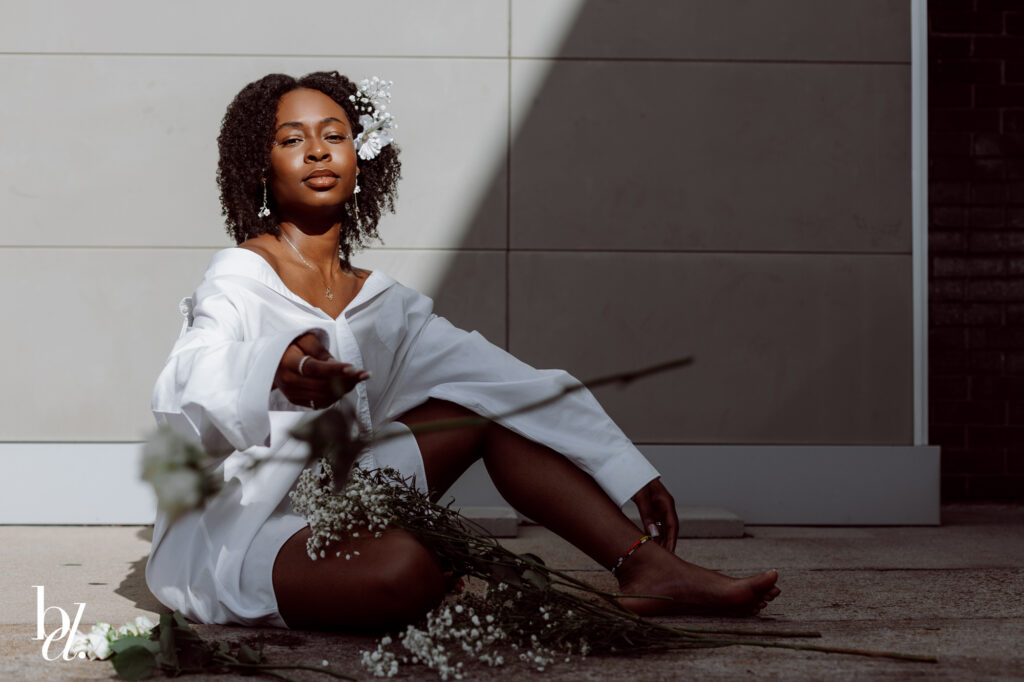 direct sunlight portrait of black girl with baby breath flowers with directional light