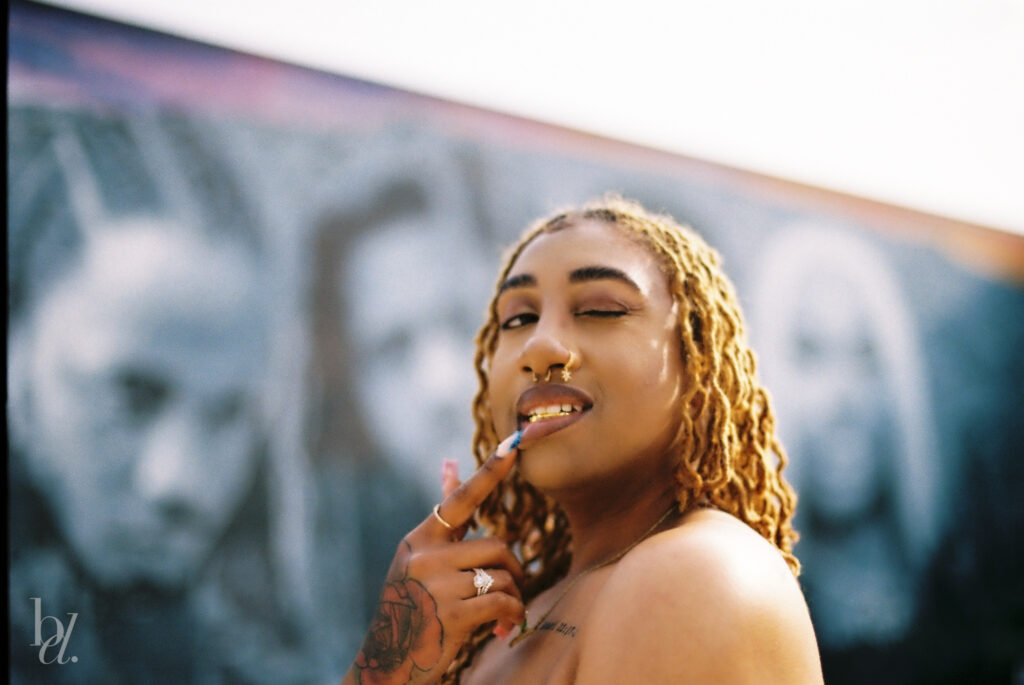 Woman posing in front of the Dreamville mural on Davie Street, captured on film