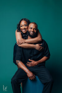 Bride embracing groom from behind during their Raleigh just married studio portraits
