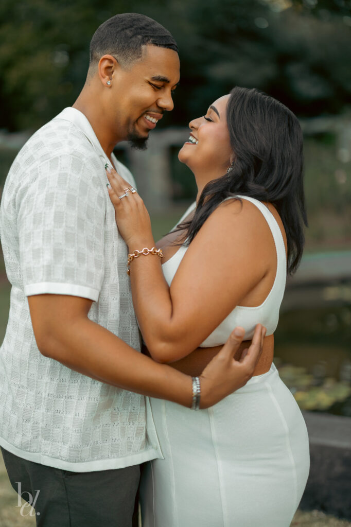 Couple laughing together after the proposal during a garden engagement photoshoot in Raleigh.