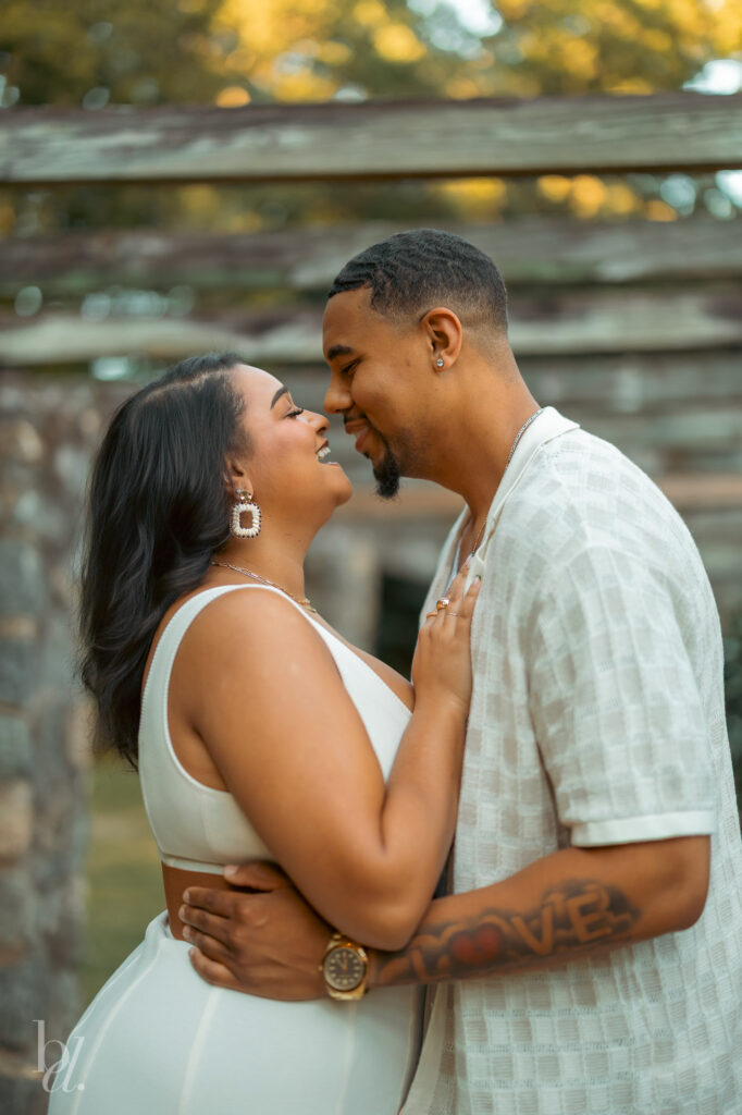Romantic close-up of a couple smiling face to face during a Raleigh engagement session in the Rose Garden.