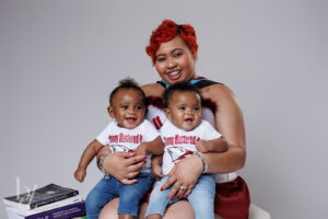 Mother holding twins during studio graduation portraits