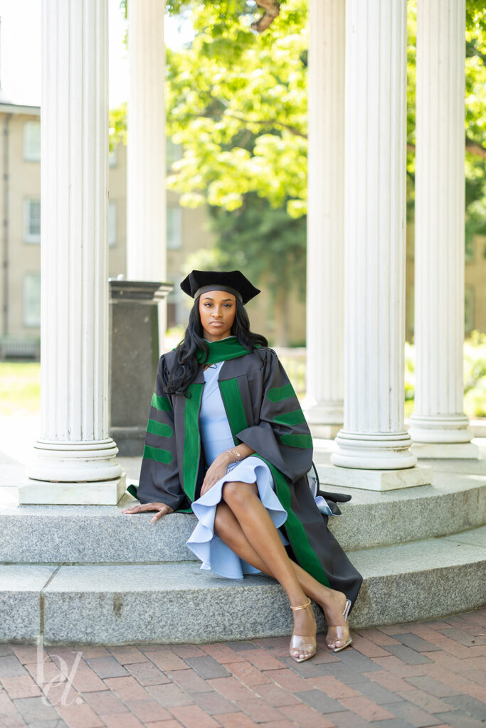 doctoral graduate seated portrait at UNC Old Well steps