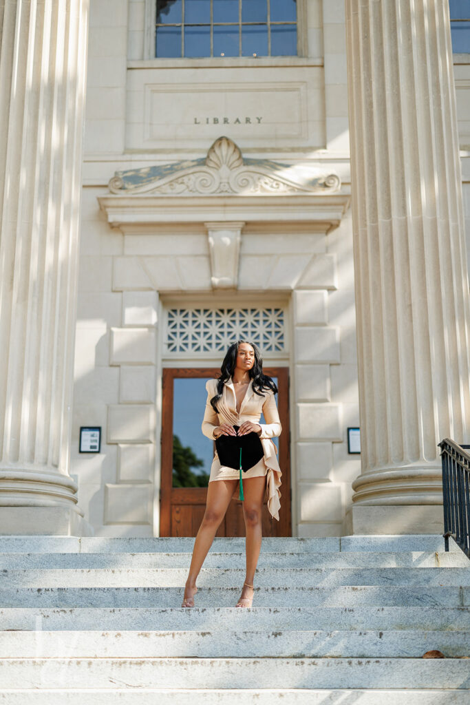editorial graduation portrait on UNC campus Wilson Library steps in beige outfit