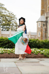Duke doctoral graduate twirling Mexican flag during graduation photo session