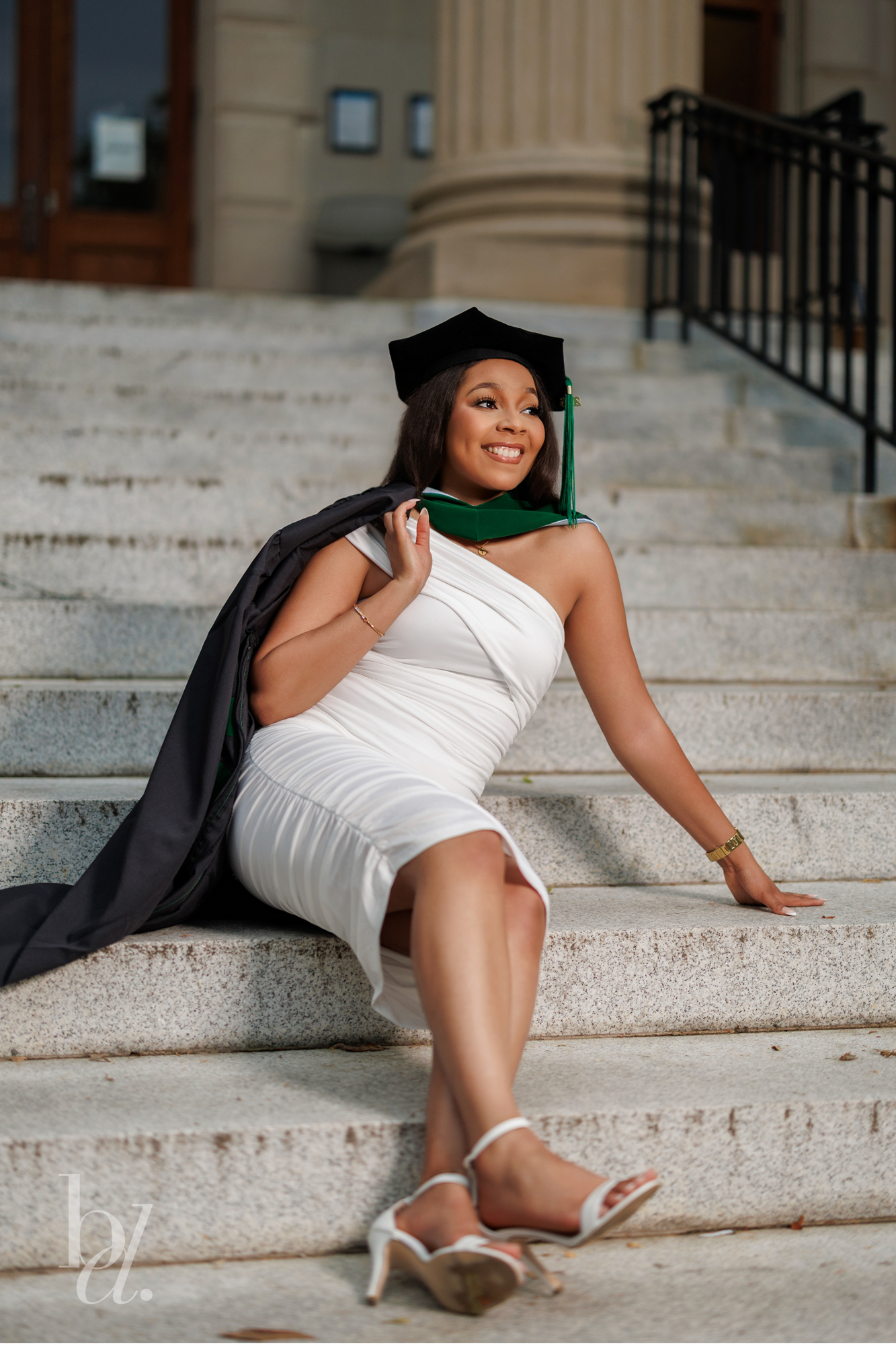 UNC School of Medicine graduate sitting on Wilson Library steps during graduation photo shoot