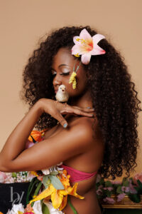 Birthday portrait of teen girl with florals and one of her live baby chicks in studio