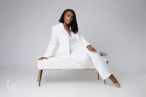 Raleigh grad photos of doctoral graduate wearing white suit in studio