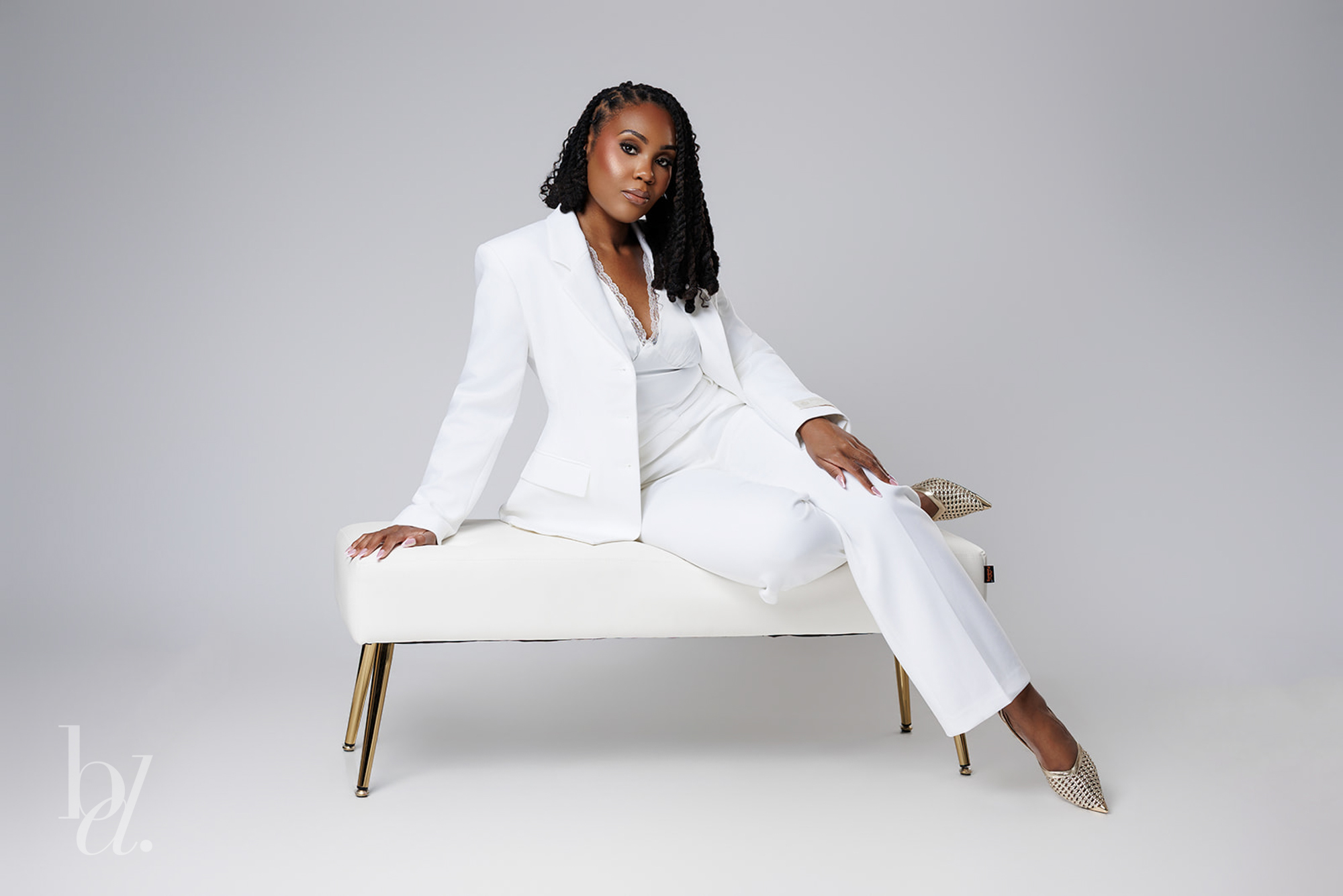 Raleigh grad photos of doctoral graduate wearing white suit in studio