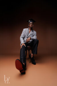 Graduate wearing a graduation cap seated for an editorial graduation portrait.